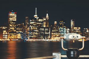New Your City skyline with binoculars at night, USA.