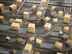 Cardboard boxes on conveyor roller in distribution warehouse, De
