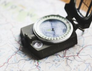 Closeup of compass on the map journey planning