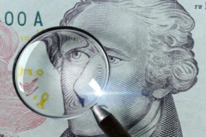 Dollar under a magnifying glass isolated