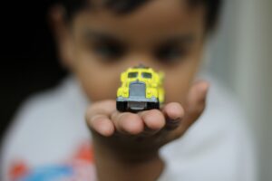 Kid playing with his toy truck