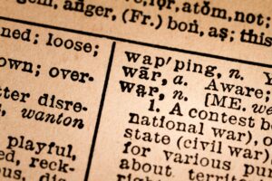 Close-up of an Opened Dictionary showing the Word WAR