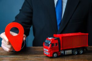 Truck and businessman with red location pin.