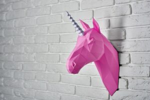 Bright pink unicorn hanging on the wall