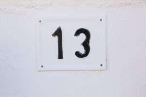 House number Thirteen on Stone Wall close-up