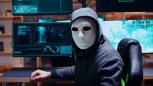 Wanted cyber criminal wearing a white mask