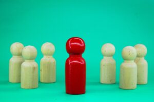 A wooden figure stands in front of the team to show influence and empowerment.