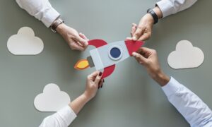Business people with startup rocket