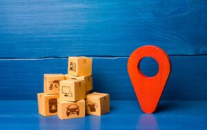 Red location pointer symbol and cardboard boxes