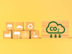 Reducing carbon footprint concept with icons on wooden blocks.
