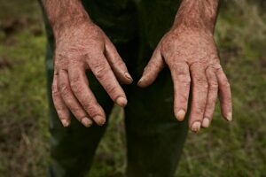 Crop hands of aged male worker