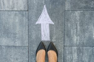 Feet and arrow on road.