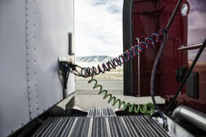 Power cables connecting the cab and the trailer of a class 8 commercial truck.