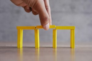 Hand add wooden blocks between the gap to complete the bridge.