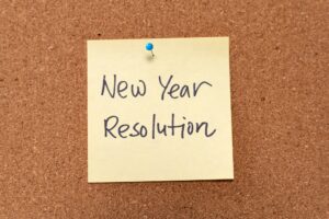 New Year resolution written on yellow sticky note pad