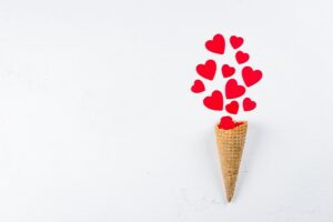 Ice Cream or Cone with Red Hearts on white Background. Top View. Love or Valentine's Day Concept