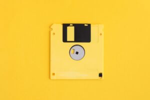 Yellow floppy disk on yellow background